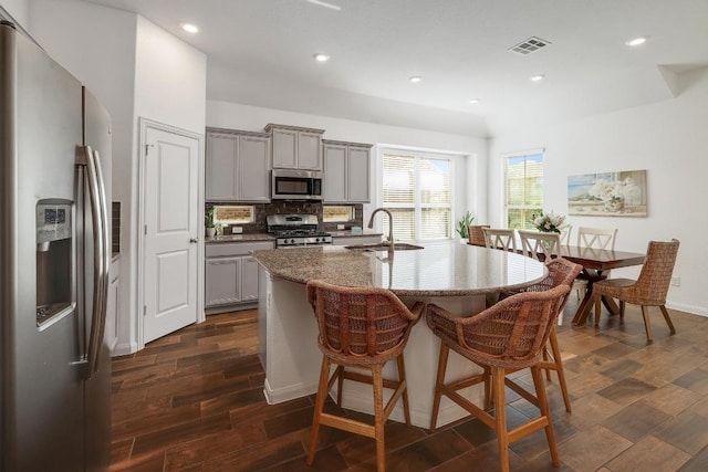 2229 Sauterne Dr, Leander, TX 78641 - kitchen featuring gray cabinetry, stainless steel appliances, a sink, and visible vents