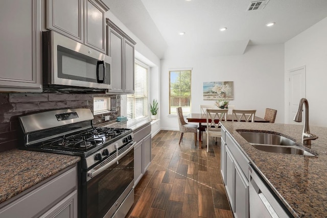 2229 Sauterne Dr, Leander, TX 78641 - kitchen with decorative backsplash, recessed lighting, a sink, dark stone countertops, and stainless steel appliances