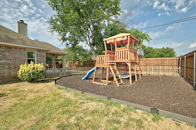 view of play area featuring a lawn and a fenced backyard