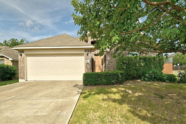 view of front of house featuring brick siding, a garage, driveway, and a front yard