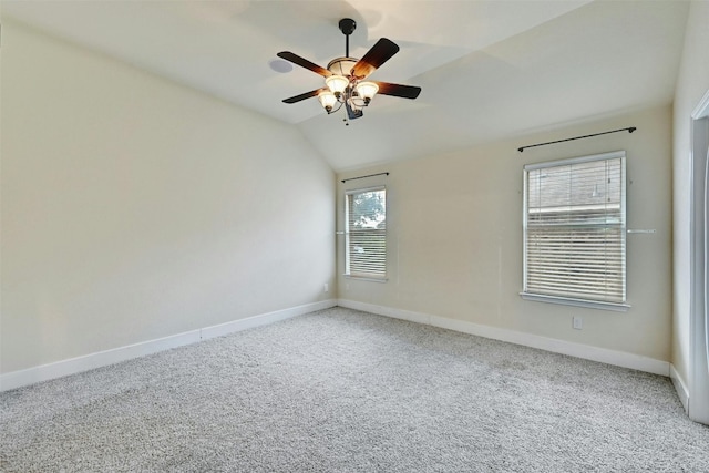 unfurnished room featuring baseboards, carpet flooring, and lofted ceiling