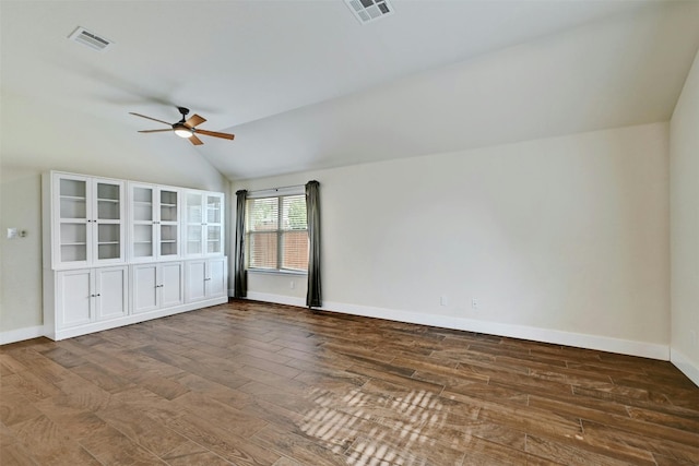 empty room featuring a ceiling fan, baseboards, visible vents, and wood finished floors