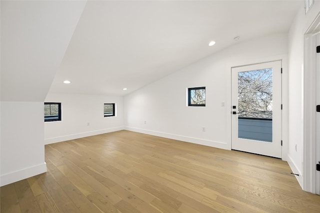 additional living space featuring recessed lighting, baseboards, vaulted ceiling, and light wood-type flooring