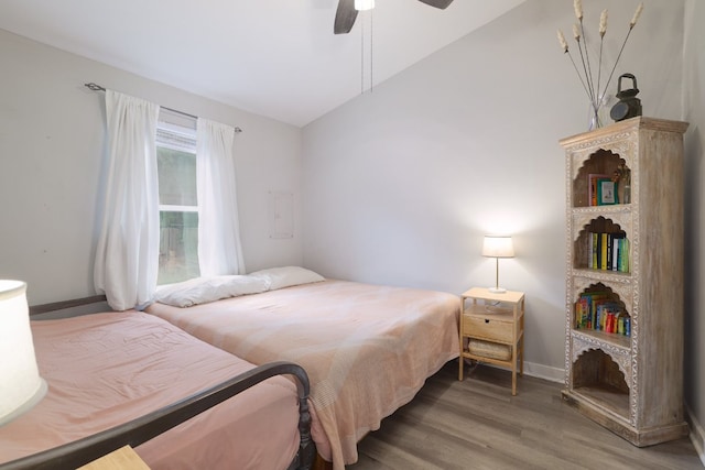 bedroom featuring baseboards, a ceiling fan, vaulted ceiling, and wood finished floors