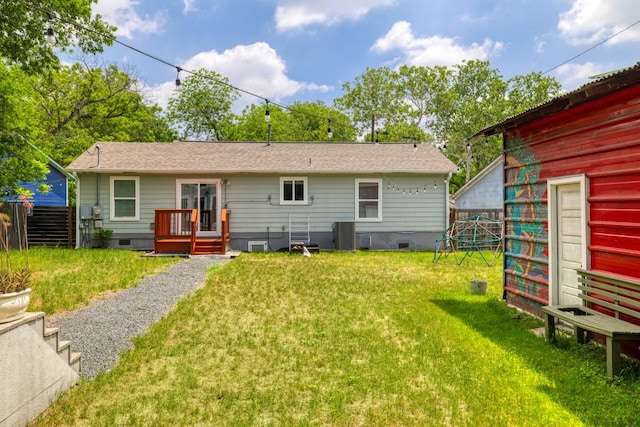 rear view of property featuring a yard, crawl space, central AC, and fence