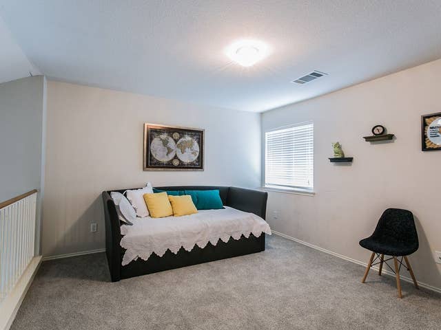 carpeted bedroom with baseboards and visible vents