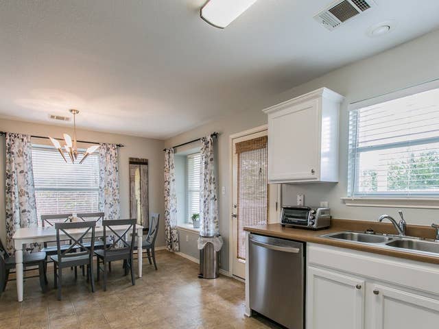 kitchen featuring a sink, dishwasher, a healthy amount of sunlight, and a toaster