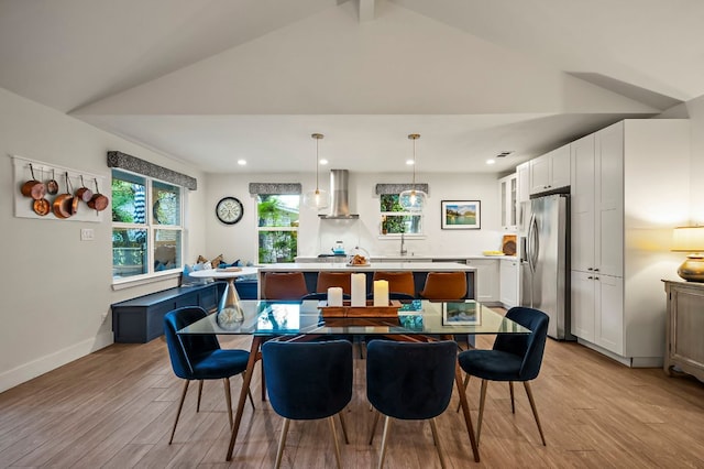 dining room featuring recessed lighting, light wood-style flooring, and lofted ceiling