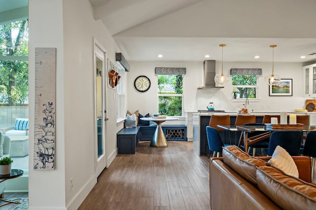 living room with baseboards, wood-type flooring, recessed lighting, and lofted ceiling