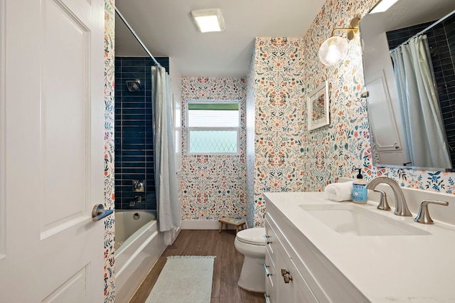bathroom featuring vanity, wood finished floors, toilet, shower / bathtub combination with curtain, and wallpapered walls