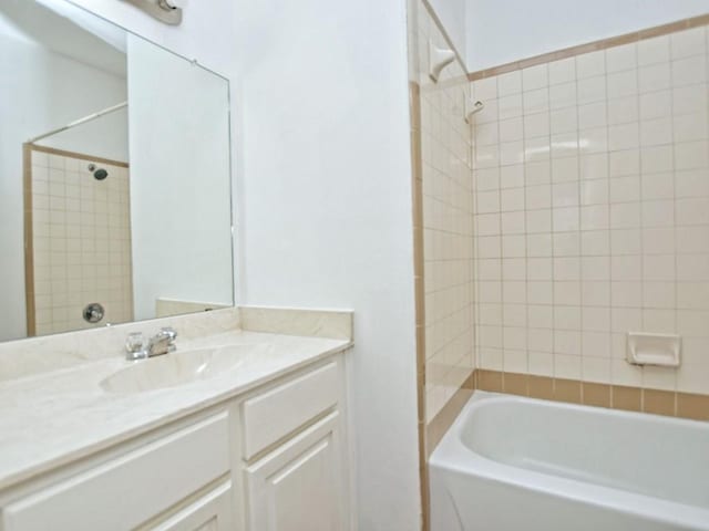 bathroom with vanity and shower / washtub combination
