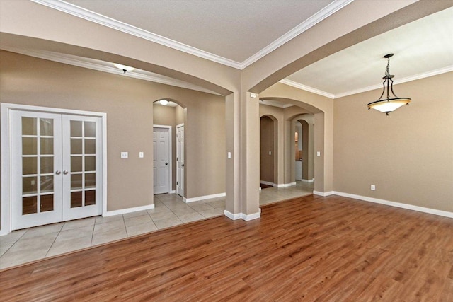 3705 Derby Trl, Round Rock, TX 78681 - spare room featuring wood finished floors, arched walkways, ornamental molding, and french doors