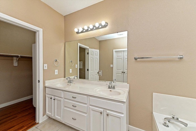 3705 Derby Trl, Round Rock, TX 78681 - bathroom with double vanity, a bathtub, and a walk in closet