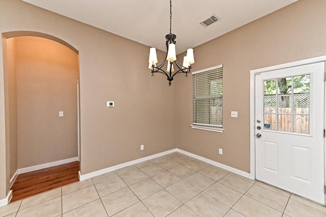 3705 Derby Trl, Round Rock, TX 78681 - unfurnished dining area featuring arched walkways, light tile patterned floors, and a chandelier