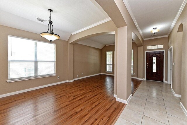 3705 Derby Trl, Round Rock, TX 78681 - foyer with arched walkways, ornamental molding, and light wood-style flooring