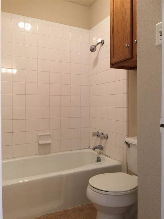 full bath with tile patterned flooring, shower / bath combination, and toilet