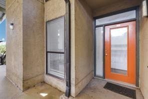property entrance with stucco siding