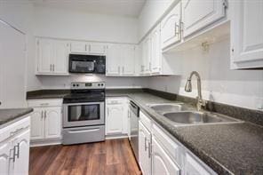 kitchen with a sink, dark countertops, white cabinets, and stainless steel appliances