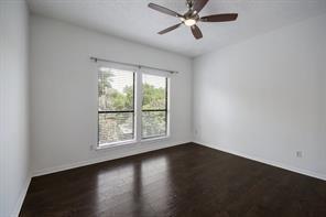1910 Robbins Pl Unit 301, Austin, TX 78705 - spare room featuring a ceiling fan, dark wood-type flooring, and baseboards