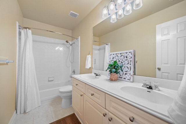 bathroom with a sink, tile patterned flooring, double vanity, and visible vents