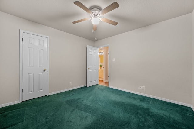 unfurnished bedroom with a ceiling fan, baseboards, and dark carpet