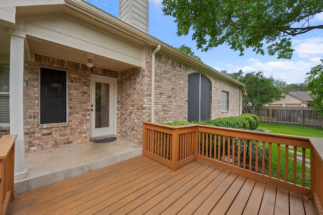 wooden deck featuring fence and a lawn