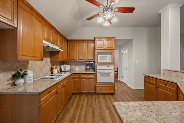 kitchen featuring ceiling fan, white appliances, light wood-style flooring, decorative backsplash, and under cabinet range hood