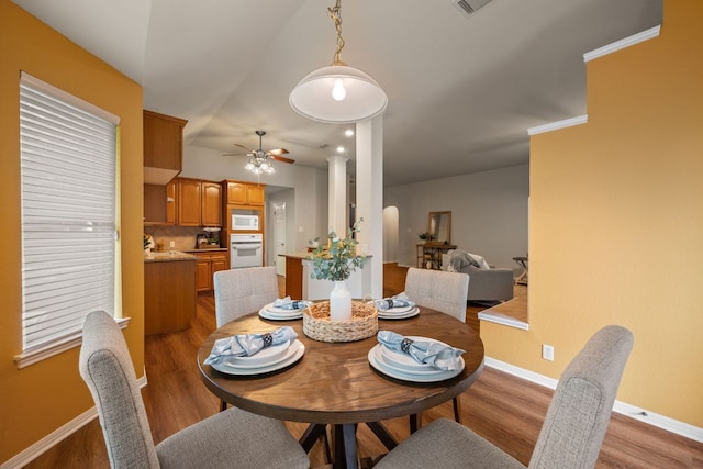 dining room with ceiling fan, baseboards, and light wood-type flooring