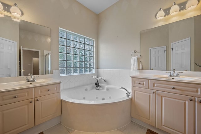 bathroom featuring two vanities, a shower stall, and a sink