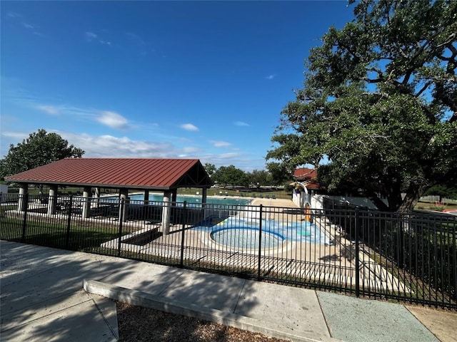 view of pool featuring fence, a fenced in pool, and a gazebo
