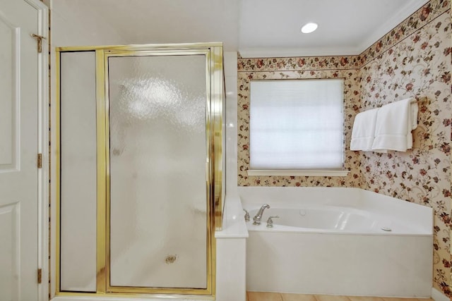 full bathroom with a stall shower, a bath, and wallpapered walls