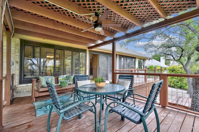 wooden deck featuring a ceiling fan and outdoor dining space