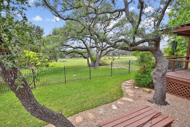 view of yard featuring fence and a wooden deck