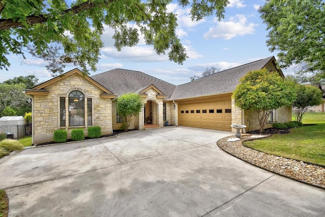 view of front of house featuring concrete driveway, a front yard, an attached garage, and stone siding