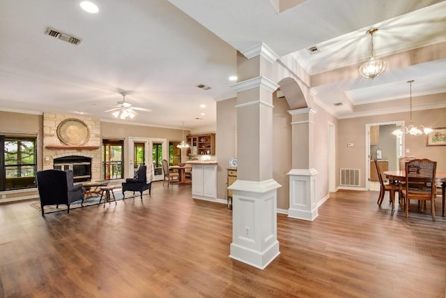 living room featuring crown molding, ornate columns, and visible vents