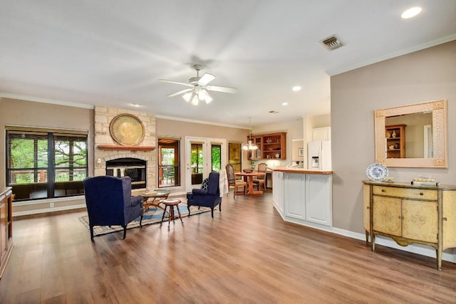 living room with plenty of natural light, wood finished floors, and visible vents
