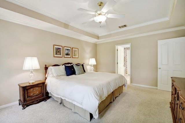 bedroom featuring crown molding, a tray ceiling, visible vents, and light carpet