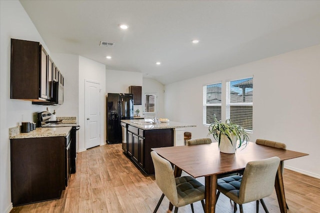 15005 Bajada Rd, Manor, TX 78653 - dining room with light wood-type flooring, recessed lighting, vaulted ceiling, and baseboards