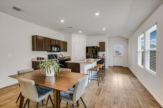 15005 Bajada Rd, Manor, TX 78653 - dining space with lofted ceiling, light wood finished floors, recessed lighting, and baseboards