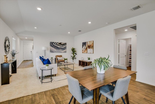 dining room featuring recessed lighting, baseboards, wood finished floors, and visible vents