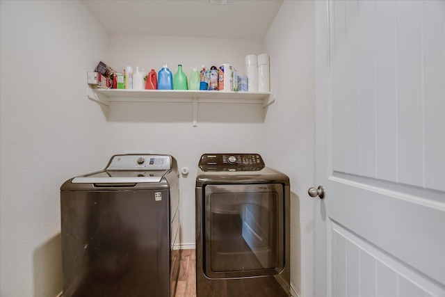 15005 Bajada Rd, Manor, TX 78653 - laundry area with washing machine and clothes dryer and wood finished floors