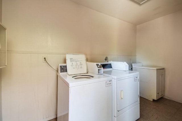 community laundry room with separate washer and dryer and wainscoting
