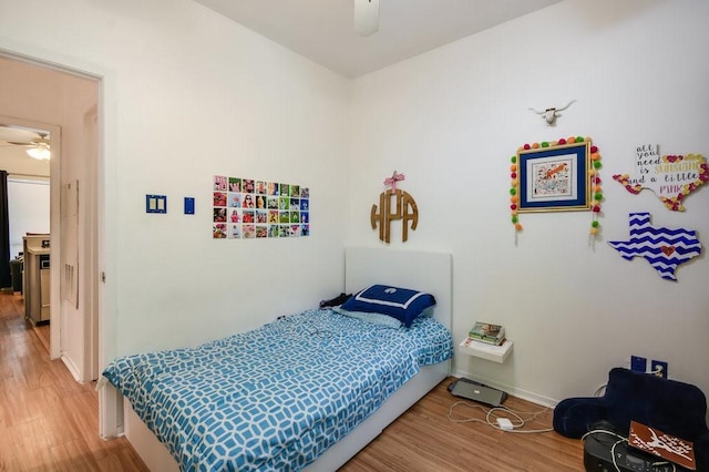bedroom with baseboards and wood finished floors