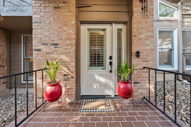 doorway to property with brick siding