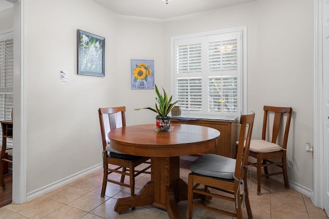 dining area featuring baseboards and light tile patterned floors