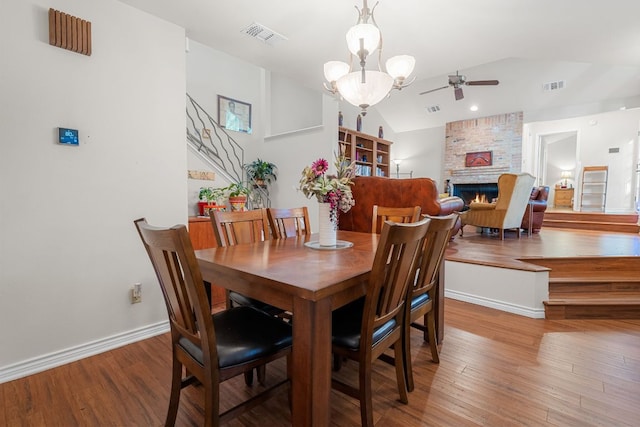 dining room with visible vents, ceiling fan, lofted ceiling, and wood finished floors