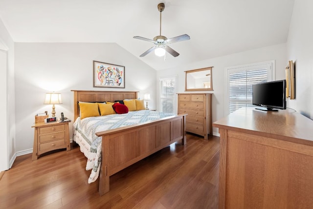 bedroom with baseboards, light wood-style flooring, ceiling fan, and lofted ceiling
