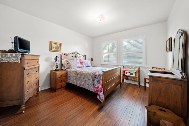 bedroom featuring baseboards and wood finished floors