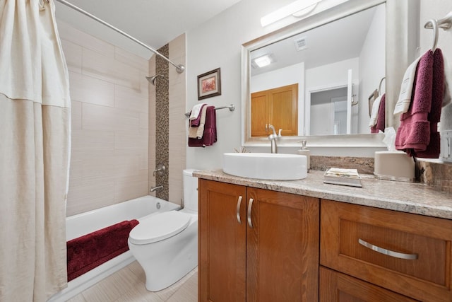 bathroom with toilet, visible vents, shower / bath combo, and vanity