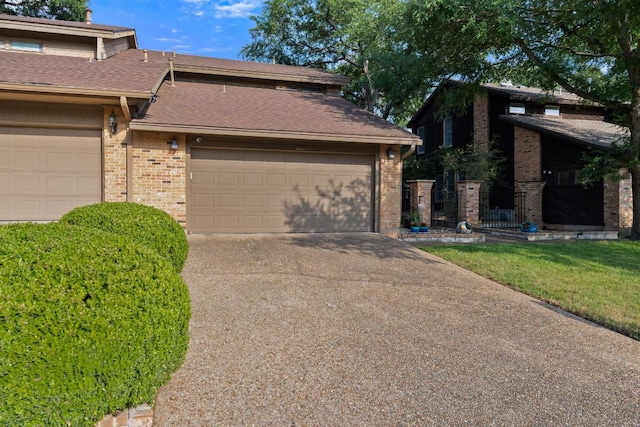 view of front of house featuring brick siding, driveway, and a garage